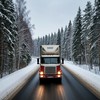 Автофура едет по шоссе через зимний лес