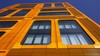 St. Petersburg, Russia - September 26, 2020: Orange and glass facade of building. Modern architecture. Skyscraper geometry. Business office park. Urban real estate. Rectangular windows. Investing. Sky...
