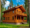 Двухэтажный деревянный дом из бруса на опушке леса